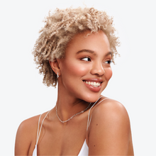 Load image into Gallery viewer, Model with short, curly, icy blonde hair